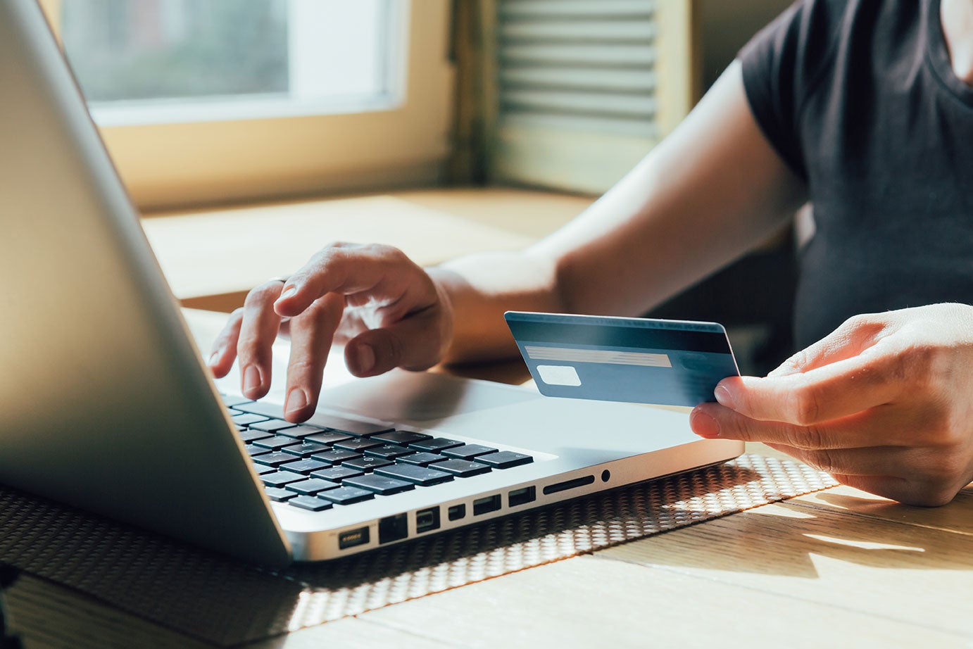 person paying with laptop