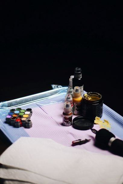 table with tattoo gun and ink